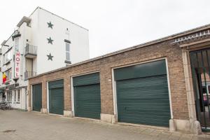a row of garage doors on a brick building at Hotel Breitner in Rotterdam