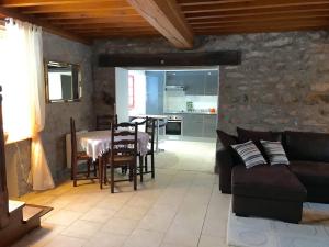 a living room with a table and a couch at Pastourelle in Quarré-les-Tombes