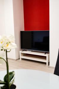 a living room with a flat screen tv on a tv stand at Apartmani Park Maksimir-Rebro in Zagreb