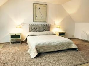 a bedroom with a large bed with two night stands at Pastourelle in Quarré-les-Tombes