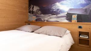 Postel nebo postele na pokoji v ubytování Hotel Compagnoni