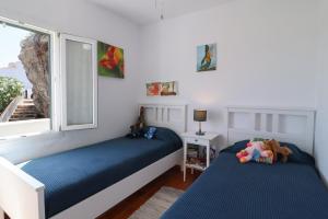 a bedroom with two beds and a window at Belvedere, Family-friendly, Nice, First-line Apartment with Stunning Beach and Sea views,AC in Arenal d'en Castell