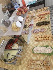a table topped with lots of different types of food at BARAKA HOTEL in Tashkent