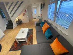 a living room with a couch and a table at The Wee Cottage by the Ferry in Gourock