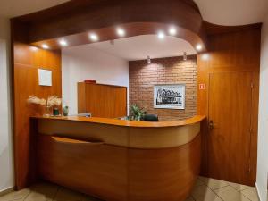 an office lobby with a wooden reception desk at Hotel Jola in Września
