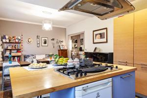 a kitchen with a stove and a counter top at A Room for You in Ferrara