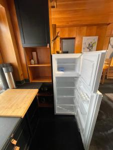 an empty refrigerator with its door open in a kitchen at Kitzbühel Zentrum in Kitzbühel