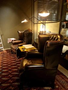 two leather chairs and a table in a living room at Boutique Hotel Borgo Nuovo in Milan