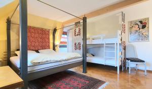 a bedroom with two bunk beds and a desk at Apartment Haus Pflingsteck nahe Europa Park Rulantica in Freiamt +29 photos