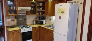 a kitchen with a white refrigerator and a stove at Lugas Apartman in Tapolca