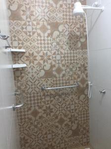 a bathroom with a shower with a tiled wall at Gira Arte Hostel in Recife