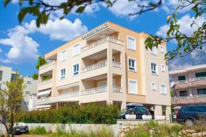 a building in front of a parking lot at Luxury Apartment Marko in Promajna