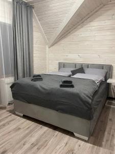 a bedroom with a large bed in a room at Happy House in Slavske