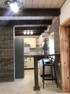 a kitchen with a table and a refrigerator at Happy House in Slavske +20 photos