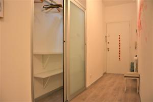 a glass closet with a mirror in a room at Sea&Bike_Apartment in Finale Ligure +15 photos