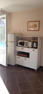 a kitchen with a white stove and a microwave at studio 5min plage agosta in Albitreccia
