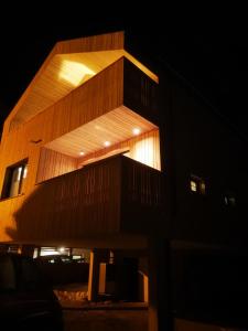a tall building with a wooden facade at night at Die Reblaus in Ladis