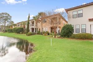 a house with a pond in front of it at 4 Bedroom house on the golf course with 2 golf carts! in Destin