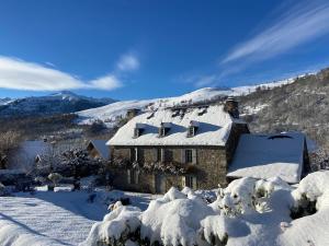 a house covered in snow on a mountain at Maison Jeanne in Saint-Paul-dʼOueil