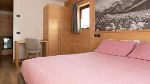 Postel nebo postele na pokoji v ubytování Hotel Compagnoni