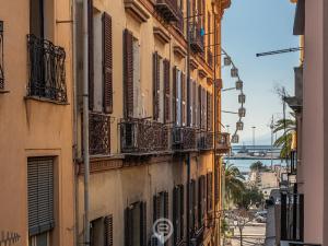 a city street with buildings with balconies and acean at Studio 73 in Cagliari