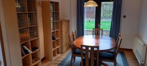 a dining room with a table and chairs and a window at Holiday Home Schwabenhaus in Kirkcaldy