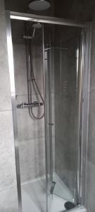 a shower with a glass door in a bathroom at Holiday Home Schwabenhaus in Kirkcaldy