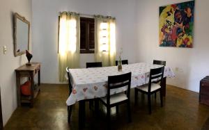 a dining room table with chairs and a white table cloth at Casa Cavalcante in Cavalcante