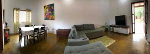 a living room with a couch and a dining room at Casa Cavalcante in Cavalcante