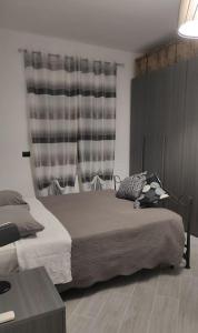 a bedroom with a bed and a table and a window at Dream- appartamento ristrutturato a Genova in Genova