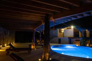 a swimming pool under a roof at night at Zazil Retreat in San Agustinillo