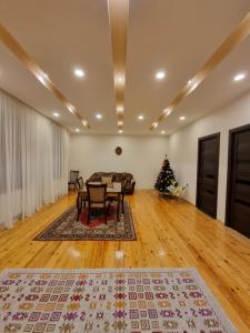 a living room with a table and a christmas tree at Shorena & Nino in Stepantsminda