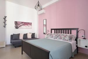 a bedroom with a bed and a couch at Family Room Scicli in Scicli