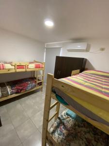 a bedroom with two bunk beds in a room at Ventanas al Sur in San Nicolás de los Arroyos