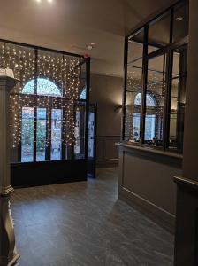 a lobby with christmas lights in the windows of a building at De&aacute;k Panzi&oacute; in Nagykőr&ouml;s