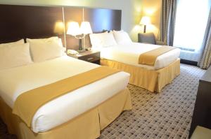 Postel nebo postele na pokoji v ubytování Aspen Grand Hotel Houston
