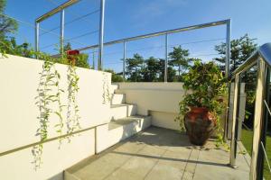 a plant in a vase sitting next to a staircase at Sunset Villa in Jimbaran