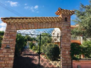 an entrance to a gate with a brick fence at Jm Vacances Serignan Studio in Sérignan