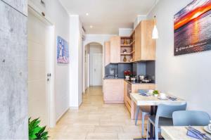 a kitchen and dining room with a table and chairs at La Perla delle Dune (Sul Mare) in Porto Cesareo