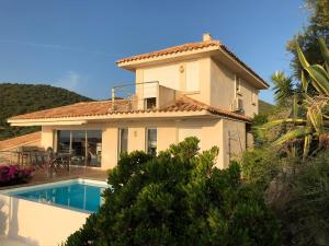 a house with a swimming pool in front of it at Villa Rosa in Conca