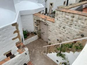 an external view of a building with a garage at En Patmo Holiday Home in Patmos