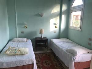 A bed or beds in a room at East Luxor Apartments with Nile views