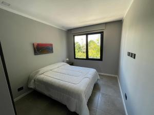 a bedroom with a bed and a window at dos569 in Mar del Plata