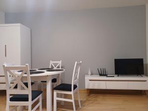 Televízia a/alebo spoločenská miestnosť v ubytovaní Apartament Artemida