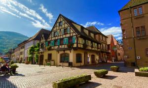 a street in a medieval town with a building at Coeur d'alsace in Kaysersberg