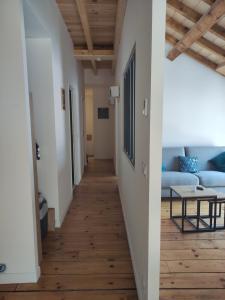 a hallway leading to a living room with wood floors at Obalie-Le Vignemale in Cauterets