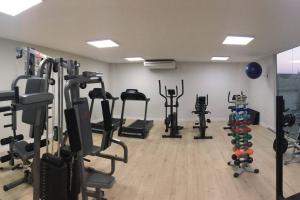a gym with several tread machines in a room at Arraial do Cabo Golden Lake Residence frente a la laguna in Arraial do Cabo