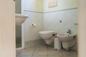 a bathroom with a toilet and a sink at Lovely beach front apartment in Santa Maria in Santa Maria