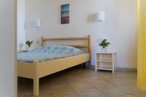 a bedroom with a bed and a table with a plant at Lovely beach front apartment in Santa Maria in Santa Maria