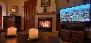 a living room with a fireplace and a television at Casa Helena in Moraira